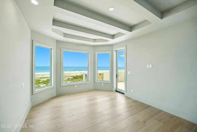 1509 Ocean Front, Neptune Beach, FL 32266 - empty room featuring a water view, wood-type flooring, recessed lighting, and beam ceiling