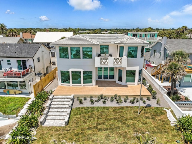 1509 Ocean Front, Neptune Beach, FL 32266 - view of front of home featuring a balcony, a front lawn, stucco siding, and a residential view