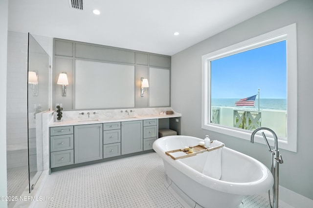 1509 Ocean Front, Neptune Beach, FL 32266 - bathroom featuring a freestanding bath, double vanity, a shower stall, recessed lighting, and a water view