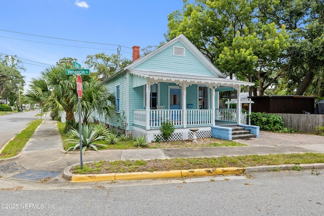 10 Venancio St, Saint Augustine, FL 32084 - view of front of house featuring covered porch and a chimney