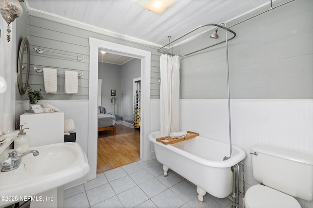 10 Venancio St, Saint Augustine, FL 32084 - ensuite bathroom with tile patterned floors, wainscoting, and wooden walls