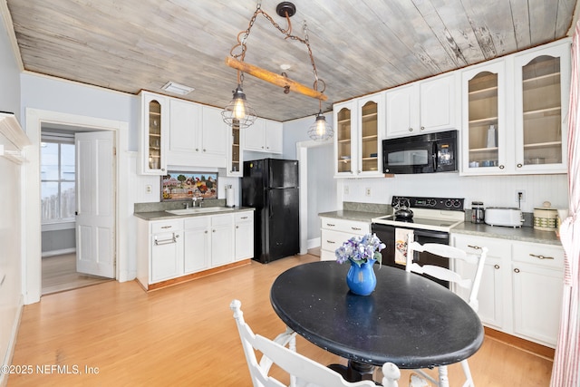 10 Venancio St, Saint Augustine, FL 32084 - kitchen featuring black appliances, wooden ceiling, white cabinetry, glass insert cabinets, and pendant lighting