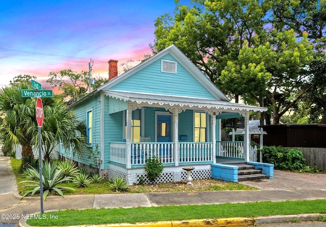 10 Venancio St, Saint Augustine, FL 32084 - view of front of home featuring covered porch and a chimney