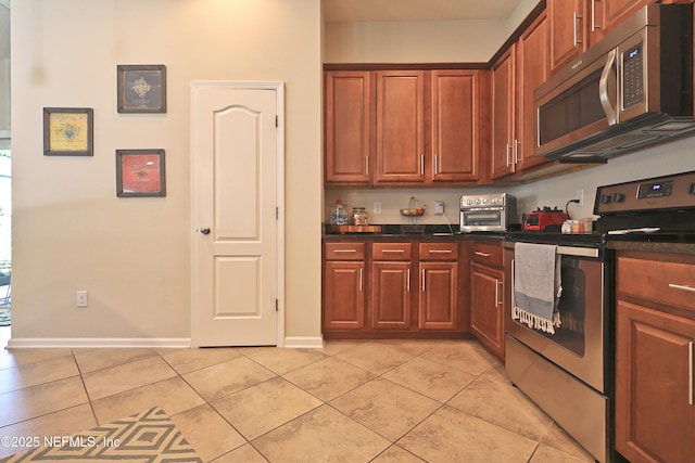 127 Colorado Springs Way, Saint Augustine, FL 32092 - kitchen featuring appliances with stainless steel finishes, light tile patterned flooring, and dark countertops