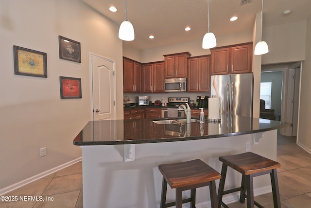 127 Colorado Springs Way, Saint Augustine, FL 32092 - kitchen featuring stainless steel appliances, light tile patterned floors, a breakfast bar, recessed lighting, and decorative light fixtures