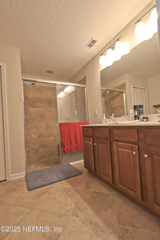 127 Colorado Springs Way, Saint Augustine, FL 32092 - bathroom with a textured ceiling, double vanity, and a stall shower