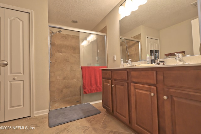 127 Colorado Springs Way, Saint Augustine, FL 32092 - full bath with a shower stall, a textured ceiling, double vanity, and tile patterned flooring