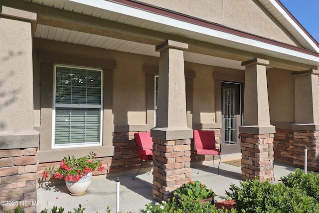 127 Colorado Springs Way, Saint Augustine, FL 32092 - property entrance with a porch, stucco siding, and stone siding