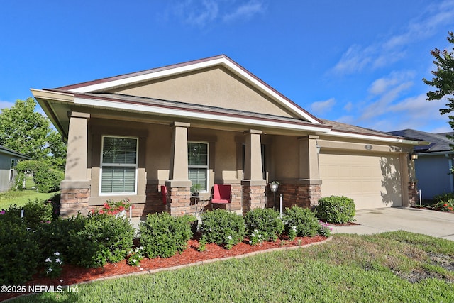 127 Colorado Springs Way, Saint Augustine, FL 32092 - view of front of home with stucco siding, covered porch, stone siding, driveway, and a garage