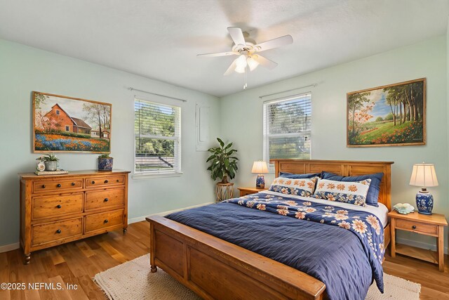 86385 Peeples Rd, Yulee, FL 32097 - bedroom featuring multiple windows, wood finished floors, and ceiling fan