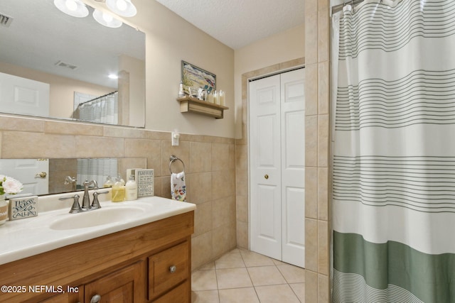 86385 Peeples Rd, Yulee, FL 32097 - full bathroom featuring a closet, vanity, tile walls, curtained shower, and tile patterned flooring