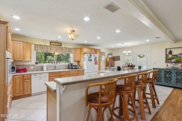 86385 Peeples Rd, Yulee, FL 32097 - kitchen with white appliances, light countertops, plenty of natural light, light tile patterned floors, and recessed lighting