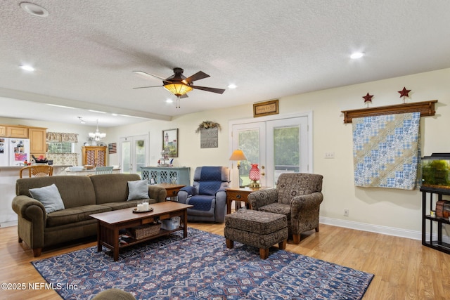 86385 Peeples Rd, Yulee, FL 32097 - living room featuring a textured ceiling, light wood-style floors, a chandelier, a ceiling fan, and recessed lighting