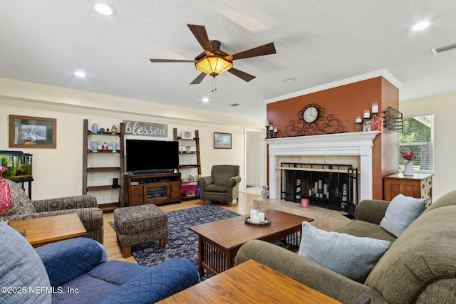 86385 Peeples Rd, Yulee, FL 32097 - living room featuring a ceiling fan, a tile fireplace, recessed lighting, a textured ceiling, and crown molding