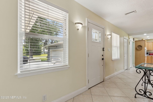 86385 Peeples Rd, Yulee, FL 32097 - entrance foyer with light tile patterned floors and baseboards