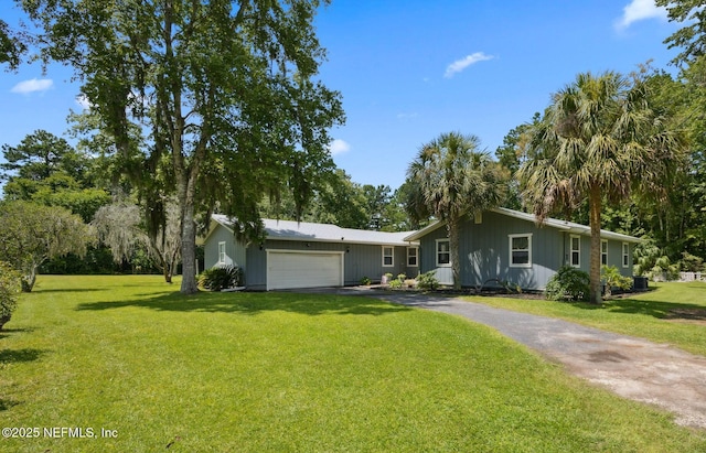 86385 Peeples Rd, Yulee, FL 32097 - ranch-style home with an attached garage, asphalt driveway, board and batten siding, and a front yard