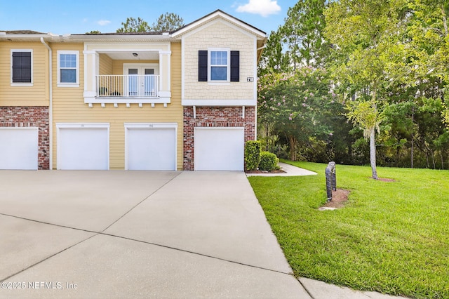 218 Larkin Pl Unit 105, Saint Johns, FL 32259 - view of front of house with driveway, a garage, a front lawn, and brick siding