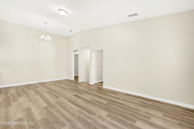 218 Larkin Pl Unit 105, Saint Johns, FL 32259 - spare room with vaulted ceiling, a chandelier, and light wood-type flooring