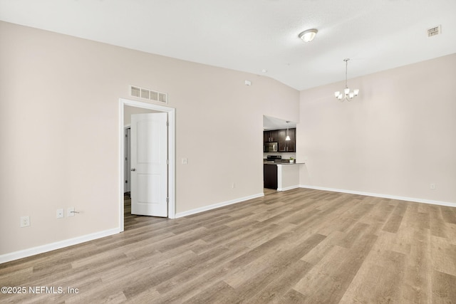 218 Larkin Pl Unit 105, Saint Johns, FL 32259 - unfurnished living room with a chandelier, lofted ceiling, and light wood-style flooring