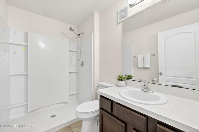 218 Larkin Pl Unit 105, Saint Johns, FL 32259 - bathroom featuring vanity, a shower, tile patterned floors, and a textured ceiling