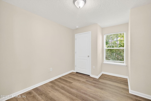 218 Larkin Pl Unit 105, Saint Johns, FL 32259 - unfurnished room with wood finished floors and a textured ceiling