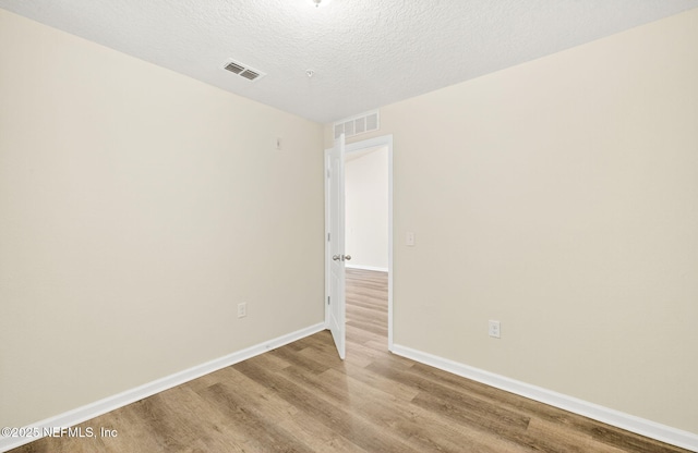 218 Larkin Pl Unit 105, Saint Johns, FL 32259 - unfurnished room with wood finished floors and a textured ceiling