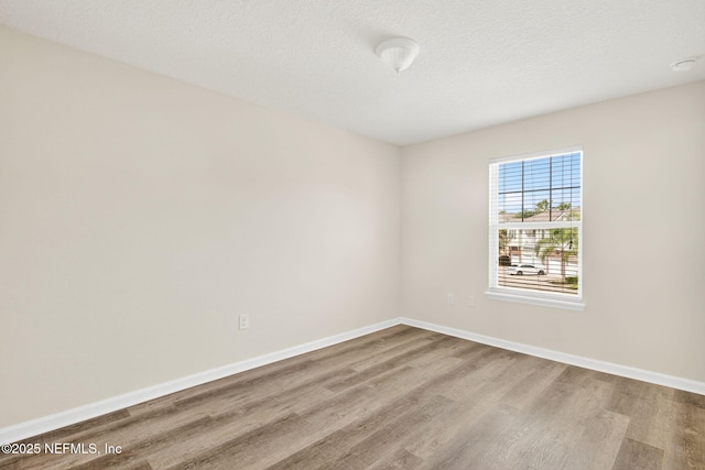 218 Larkin Pl Unit 105, Saint Johns, FL 32259 - spare room featuring wood finished floors and a textured ceiling