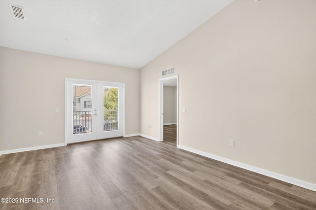 218 Larkin Pl Unit 105, Saint Johns, FL 32259 - unfurnished room featuring wood finished floors, french doors, and high vaulted ceiling