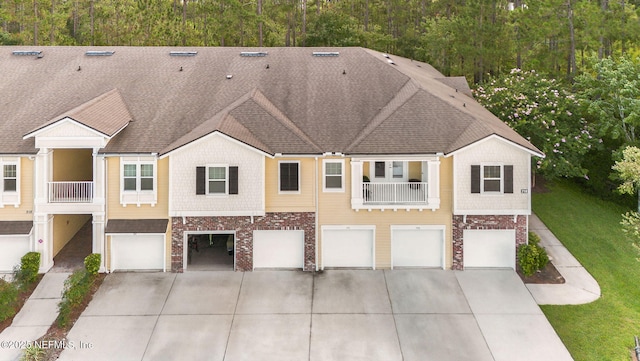 218 Larkin Pl Unit 105, Saint Johns, FL 32259 - multi unit property with driveway, a garage, brick siding, and a shingled roof