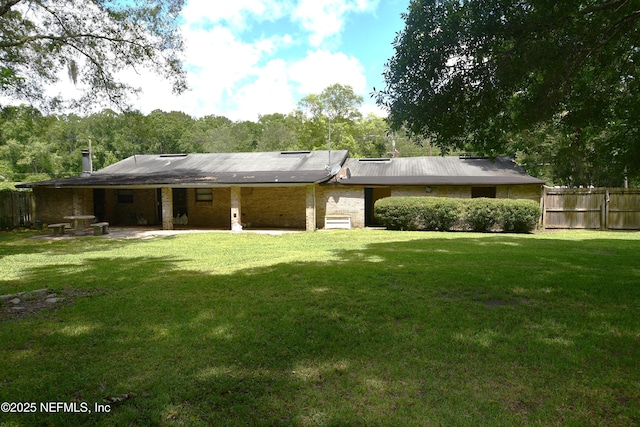 44186 Lee Dr, Callahan, FL 32011 - rear view of house featuring a patio area and brick siding