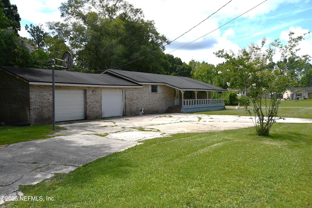 44186 Lee Dr, Callahan, FL 32011 - view of front of home with a front lawn, driveway, brick siding, and a garage