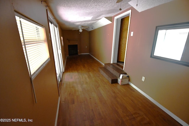 44186 Lee Dr, Callahan, FL 32011 - corridor with a textured ceiling, plenty of natural light, and wood finished floors
