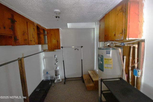 44186 Lee Dr, Callahan, FL 32011 - kitchen featuring brown cabinets, a textured ceiling, electric water heater, and carpet floors
