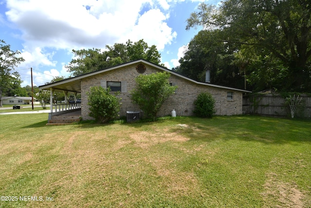 44186 Lee Dr, Callahan, FL 32011 - view of property exterior featuring brick siding and a central air condition unit