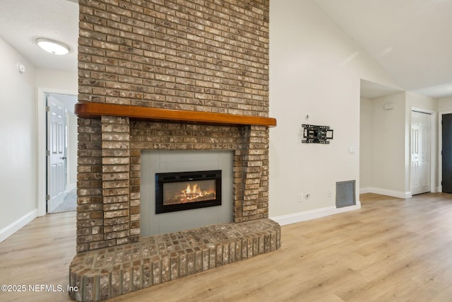 4804 Winton Cir, Saint Augustine, FL 32086 - unfurnished living room with a fireplace, wood finished floors, and lofted ceiling