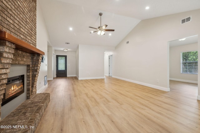 4804 Winton Cir, Saint Augustine, FL 32086 - unfurnished living room with a brick fireplace, high vaulted ceiling, ceiling fan, light wood-style flooring, and plenty of natural light