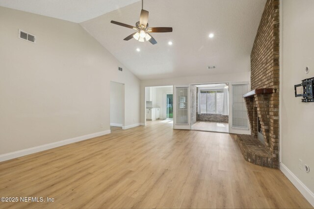 4804 Winton Cir, Saint Augustine, FL 32086 - unfurnished living room with a brick fireplace, a ceiling fan, high vaulted ceiling, light wood-style floors, and recessed lighting