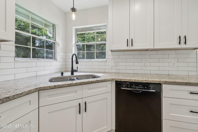 4804 Winton Cir, Saint Augustine, FL 32086 - kitchen with black dishwasher, white cabinetry, decorative backsplash, and light stone counters