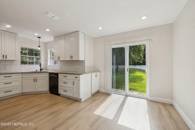 4804 Winton Cir, Saint Augustine, FL 32086 - kitchen featuring dishwasher, light wood-type flooring, decorative backsplash, white cabinets, and recessed lighting