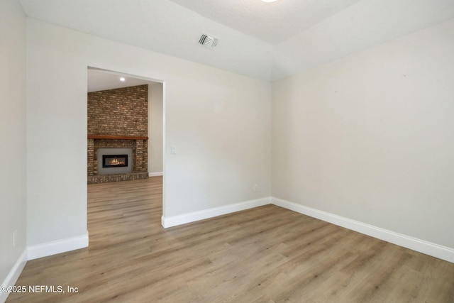 4804 Winton Cir, Saint Augustine, FL 32086 - spare room featuring wood finished floors and a brick fireplace