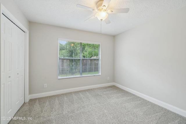 4804 Winton Cir, Saint Augustine, FL 32086 - unfurnished bedroom featuring carpet floors, a closet, a textured ceiling, and ceiling fan