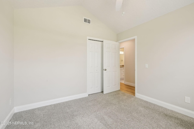 4804 Winton Cir, Saint Augustine, FL 32086 - unfurnished bedroom with light colored carpet, vaulted ceiling, and a closet