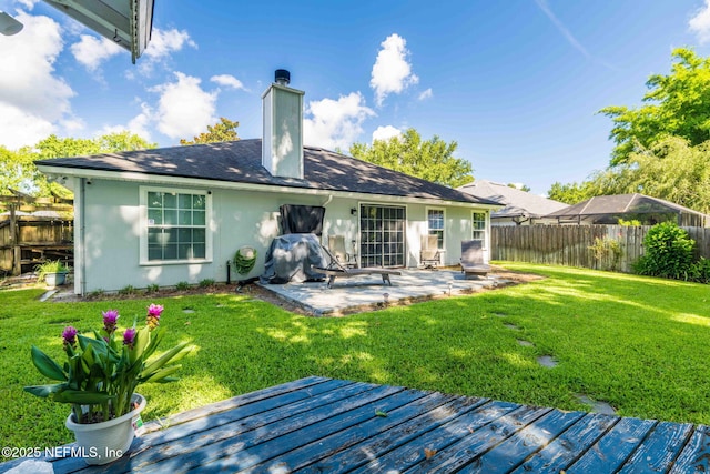 1133 Blue Sky Way, Jacksonville, FL 32225 - rear view of house featuring a fenced backyard, a wooden deck, a patio area, and stucco siding