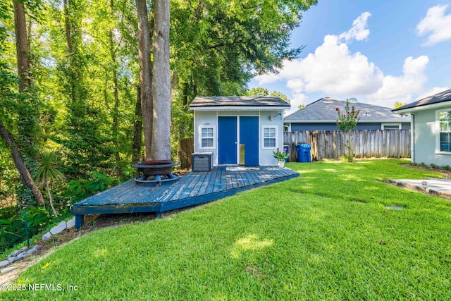 1133 Blue Sky Way, Jacksonville, FL 32225 - view of yard featuring a deck, a storage shed, and a fire pit