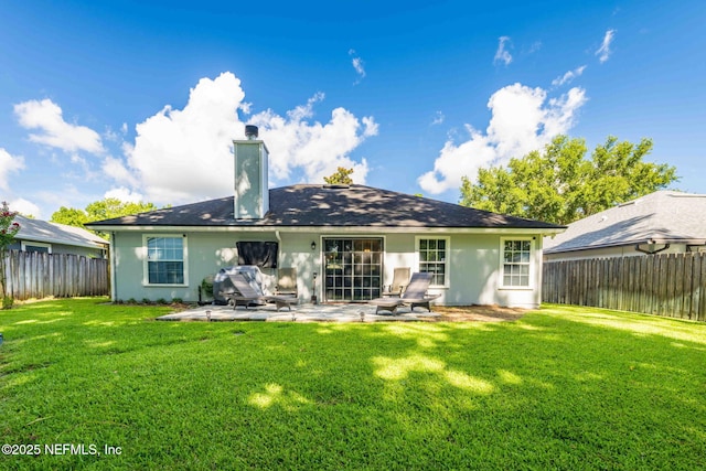 1133 Blue Sky Way, Jacksonville, FL 32225 - back of property with a fenced backyard, a patio area, a chimney, and stucco siding