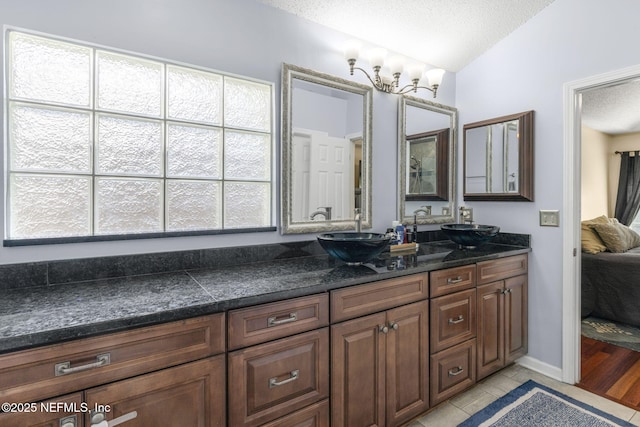 1133 Blue Sky Way, Jacksonville, FL 32225 - bathroom featuring double vanity, a textured ceiling, tile patterned floors, and ensuite bath