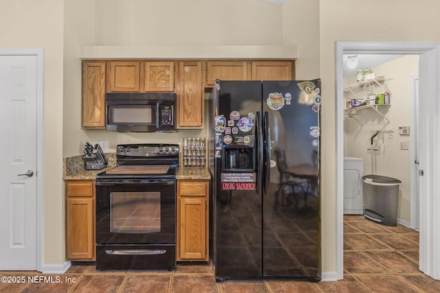 1133 Blue Sky Way, Jacksonville, FL 32225 - kitchen featuring black appliances, washer / clothes dryer, dark tile patterned floors, and light stone counters