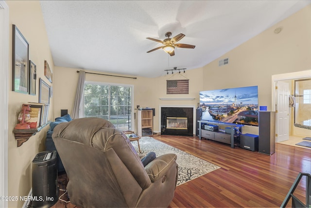 1133 Blue Sky Way, Jacksonville, FL 32225 - living area featuring a high end fireplace, wood finished floors, a ceiling fan, healthy amount of natural light, and vaulted ceiling