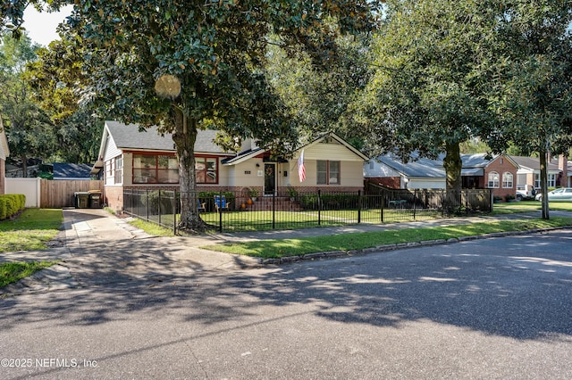 4818 Astral St, Jacksonville, FL 32205 - view of front facade featuring a fenced front yard, concrete driveway, and brick siding