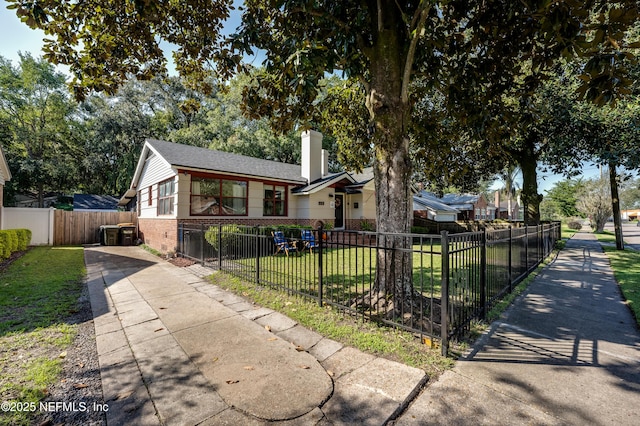 4818 Astral St, Jacksonville, FL 32205 - view of front of house with brick siding, a chimney, and a fenced front yard